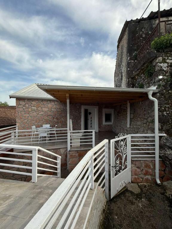 a house with a white fence in front of it at Rina House in Žabljak
