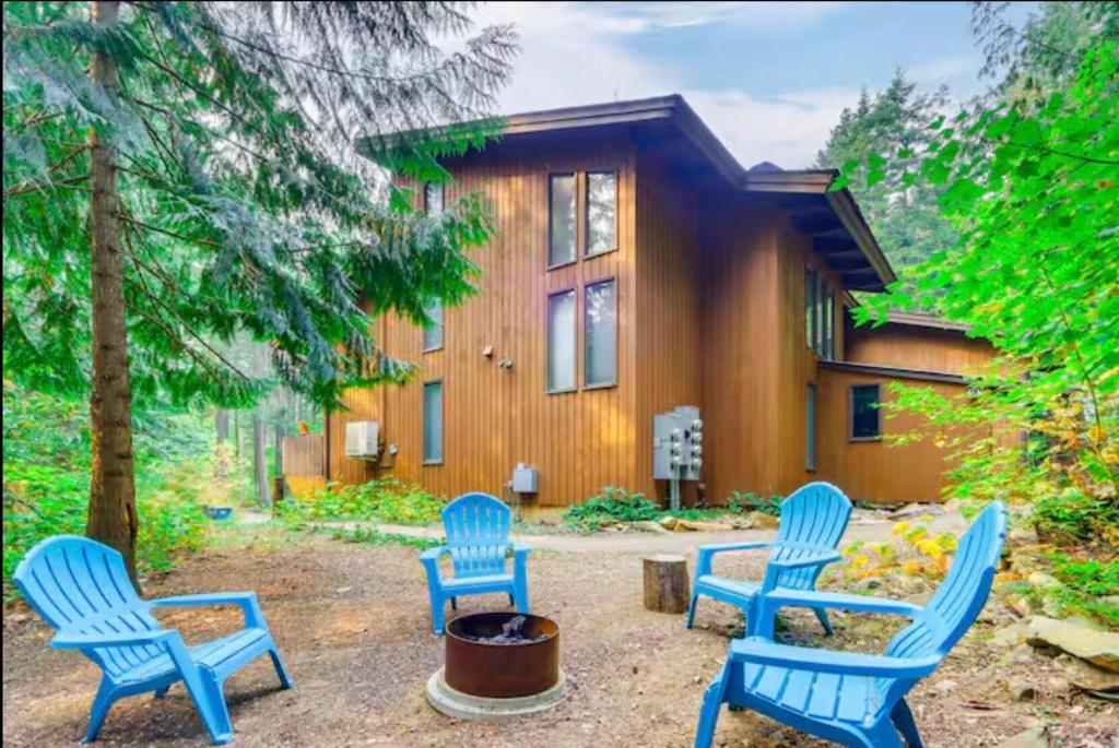 a group of blue chairs in front of a house at Twin Lakes in Rathdrum, ID in Rathdrum