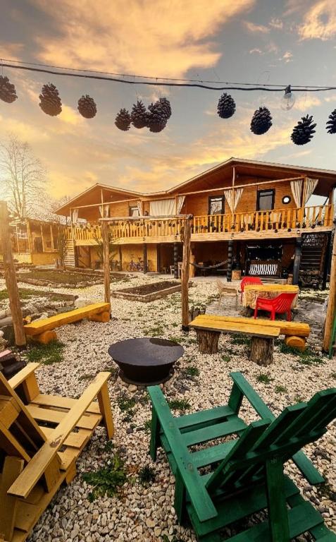 a group of chairs and tables in front of a building at Green Owl in Dedoplis Tskaro