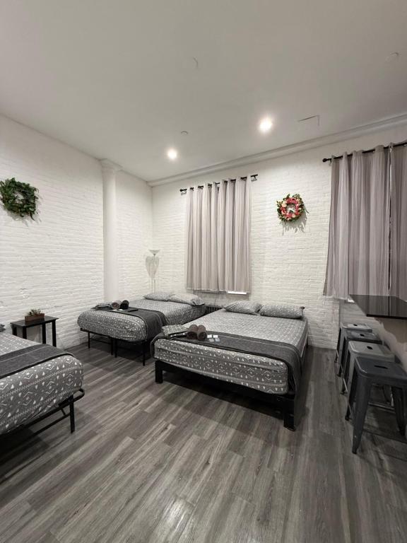 a room with three beds in a room at 31 Street Broadway Hotel in New York