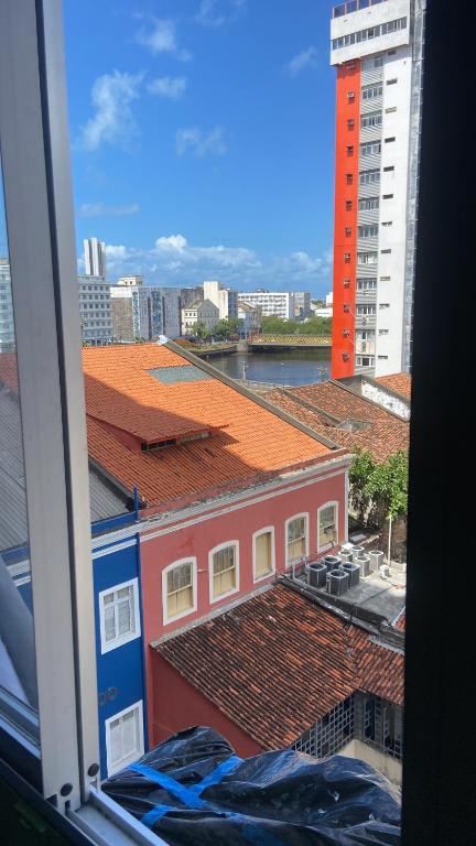 a view of the roofs of buildings from a window at Quarto Astral in Recife