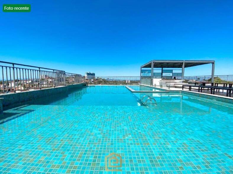 a large swimming pool on top of a building at Apartamento Studio in Arujá
