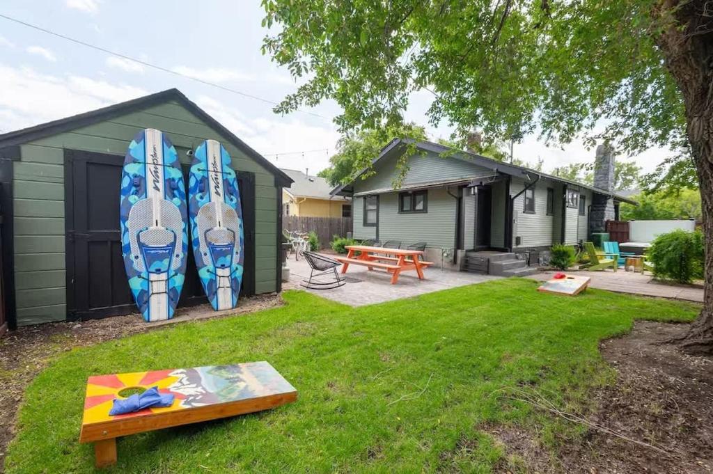 a house with a bunch of surfboards leaning against it at The Modern Cottage in Bend