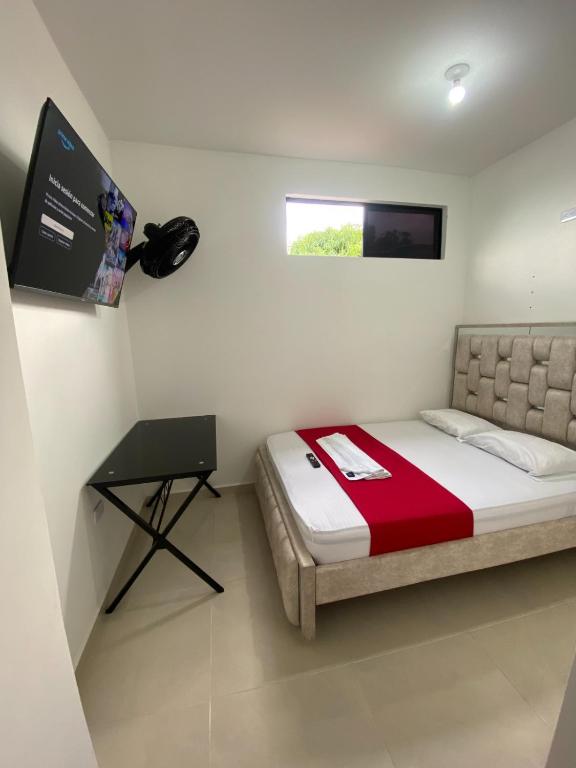 a small bedroom with a bed and a desk at Apartamento Tercer Cielo 203 in Cúcuta