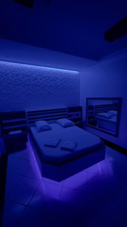a bedroom with a bed in a blue room at Hotel Costa Leste in São Paulo