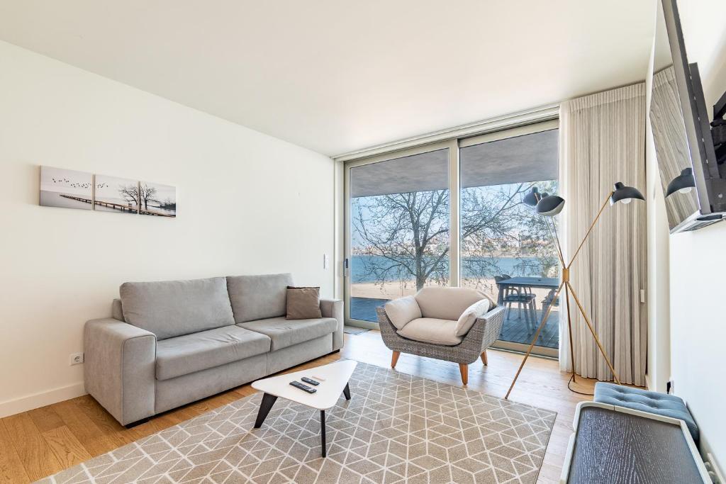 a living room with a couch and a chair at Douro Porto View in Vila Nova de Gaia
