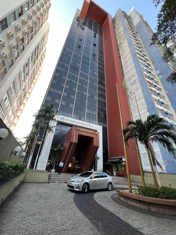 a car parked in front of a large building at Flat 308 - Vista Mar in Salvador
