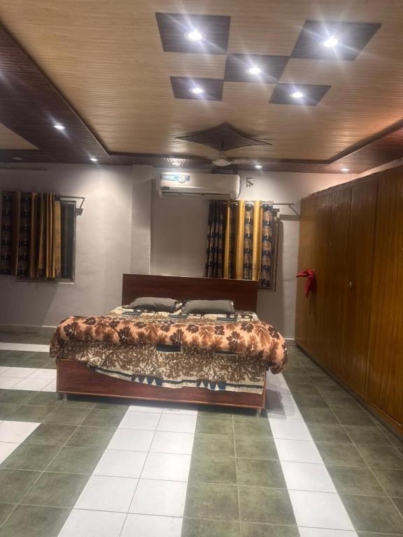 a bedroom with a large bed in a room at Hotel Kamla Palace in Haridwār