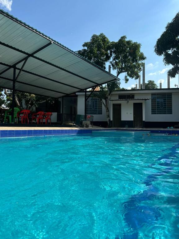 a large swimming pool with a canopy over it at San Alejo in San Joaquín