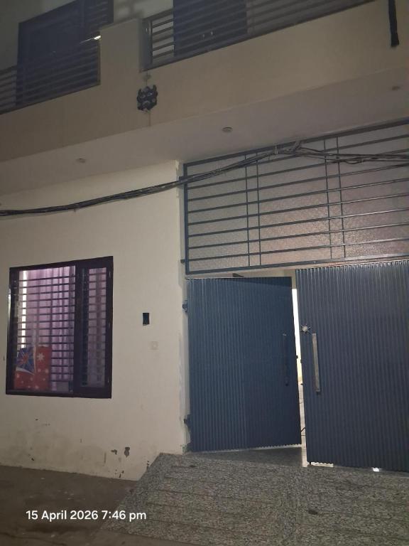 a building with a blue door and a window at SG Homestay in Amritsar