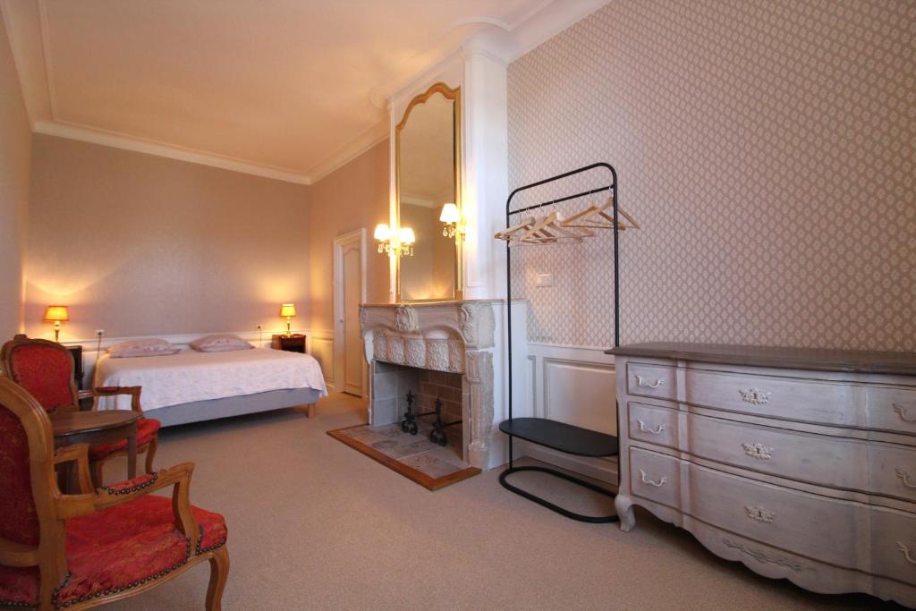 a bedroom with a bed and a dresser and a fireplace at Chambre n2 Maison dHôtes de Charme in Maizières