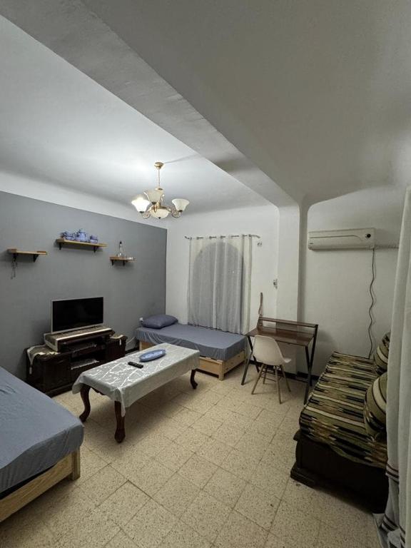 a living room with a bed and a couch at Appartement T3 équipé à Biskra in Biskra