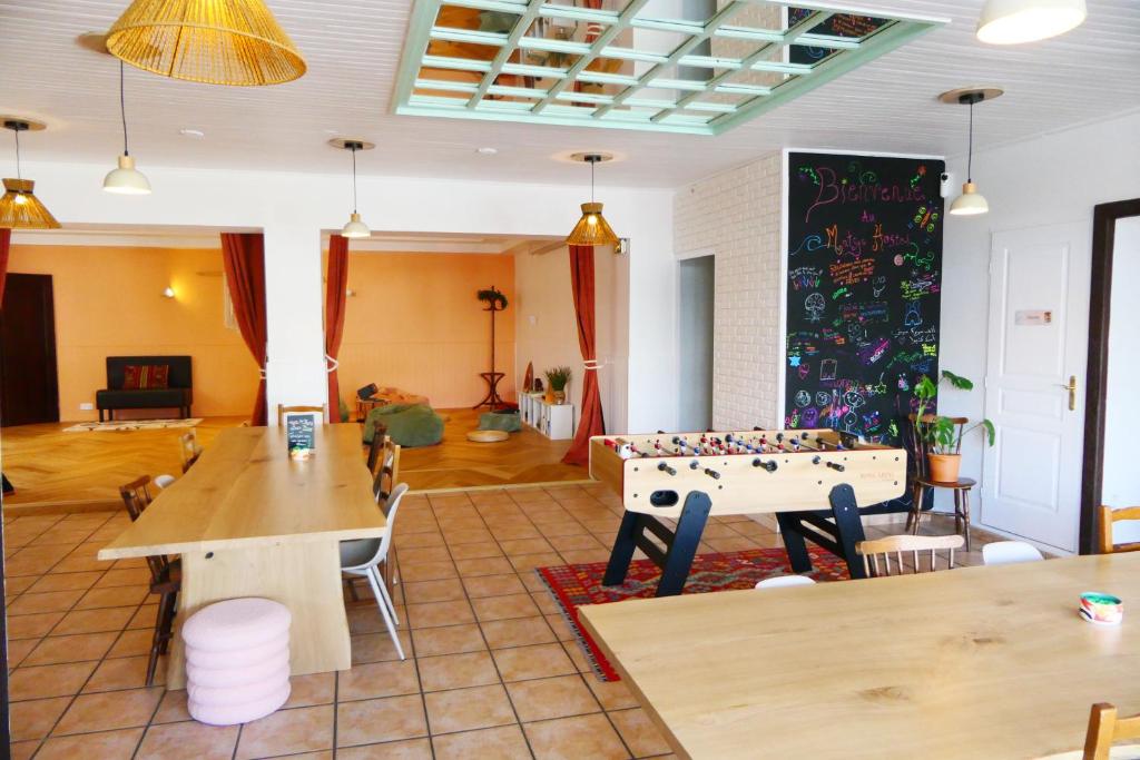 a living room with a table and a pool table at Matsya Hostel in Anglet