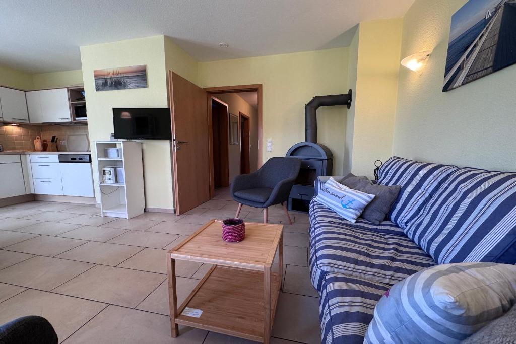a living room with a couch and a table at DHH Wald in Kellenhusen