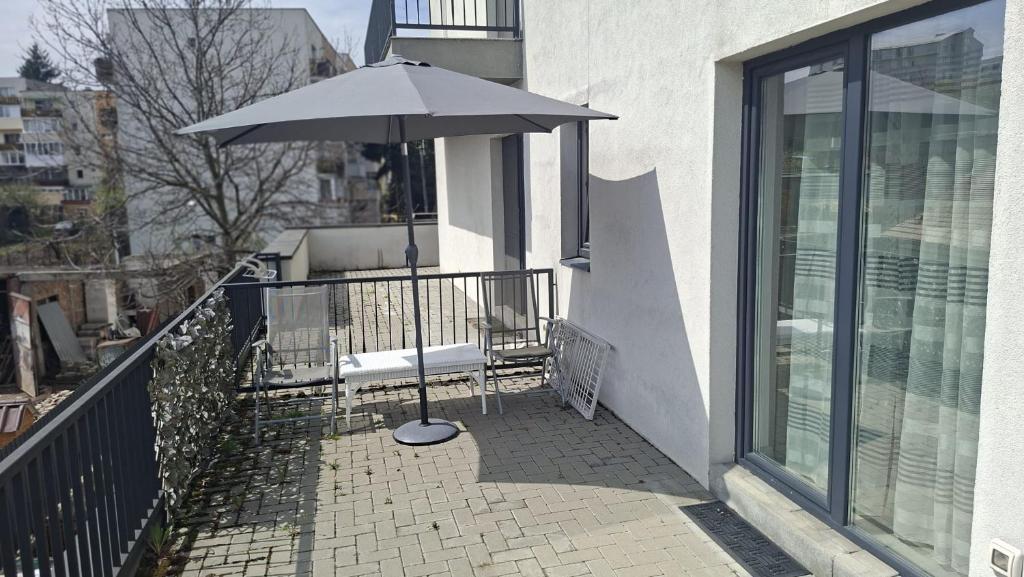 an umbrella sitting on the balcony of a building at Baman Apartment in Cluj-Napoca