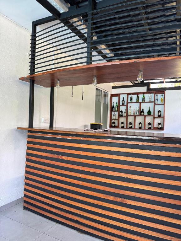 a restaurant with a wooden counter with a counter top at The Surf Loft in Weligama