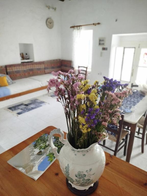 a vase filled with flowers sitting on a table at Almyra traditional residence in Andros