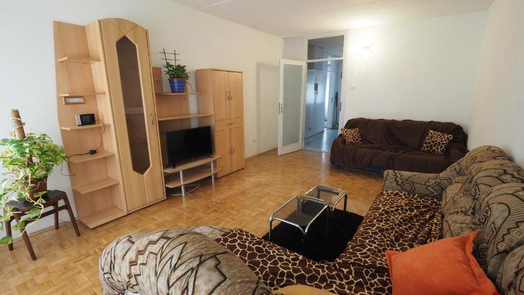 a living room with a couch and a television at Apartment Alma in Zagreb