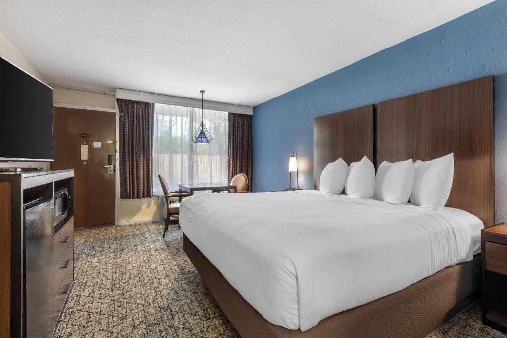 a hotel room with a large bed and a desk at Best Western Winners Circle in Hot Springs
