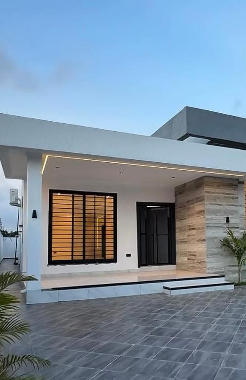 a large white house with a large window at Love One in Midrand