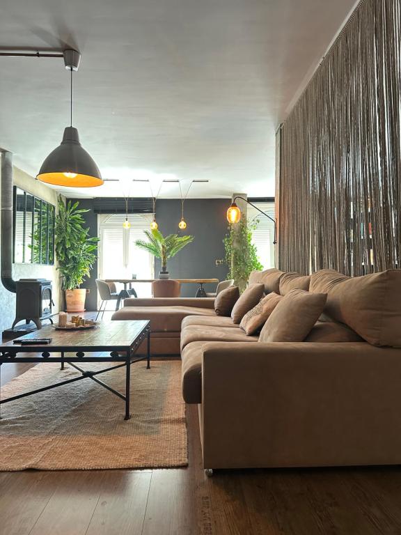 a living room with a couch and a table at LOFT "EL PARQUE" in Níjar