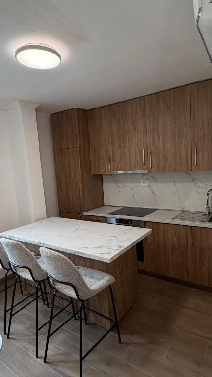 a kitchen with a table and chairs in a room at Casa Oliva in Orahovo