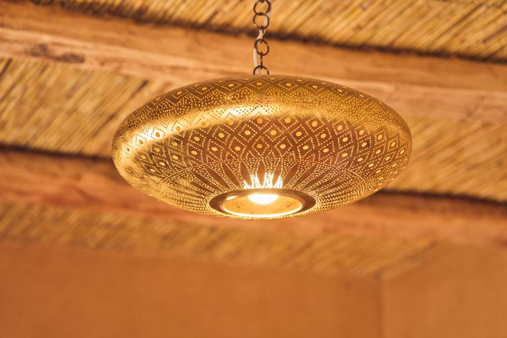 a gold chandelier hanging from a ceiling at Land of dreams in Nkob