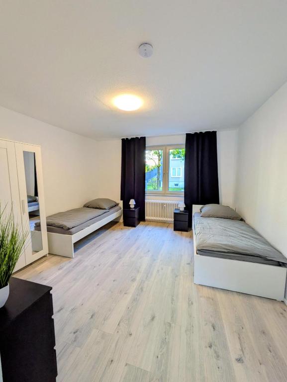 a bedroom with two beds and a window at interaktiv Appartements in Heiligenhaus - Herzogstrasse in Heiligenhaus