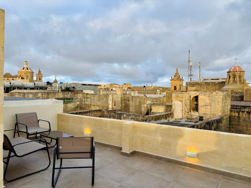 a balcony with chairs and a view of a city at VillageStay in Rabat