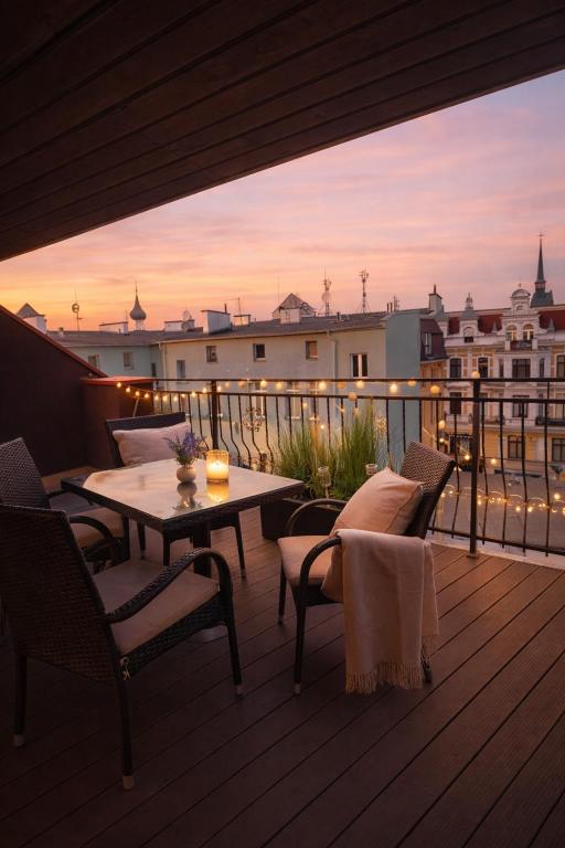 a patio with a table and chairs on a balcony at Plac 14- Apartamenty i pokoje w centrum in Świnoujście