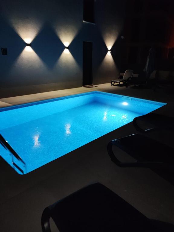 a large swimming pool in a room with lights at Rusulica Trogir in Seget Vranjica