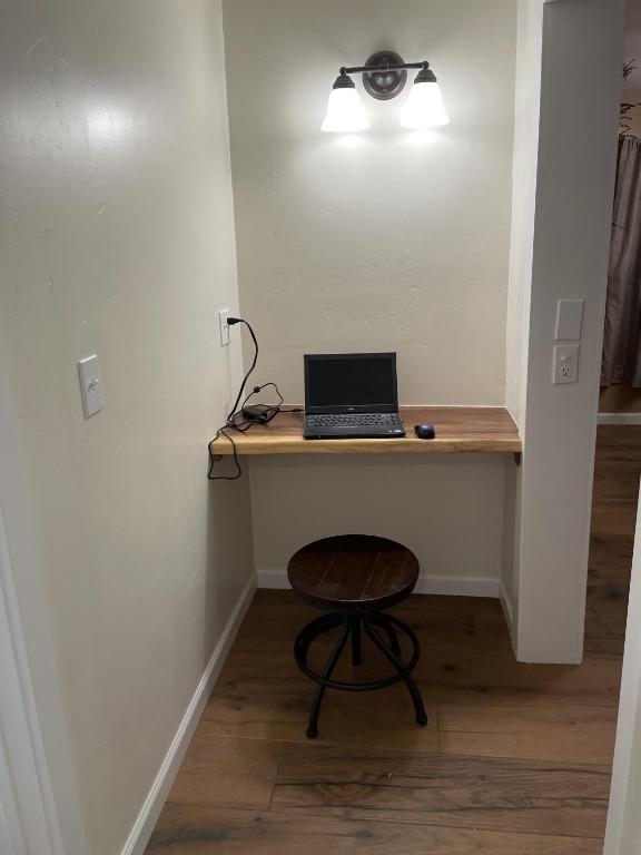 a laptop computer sitting on a desk in a room at The Cabin on Overland in Prescott