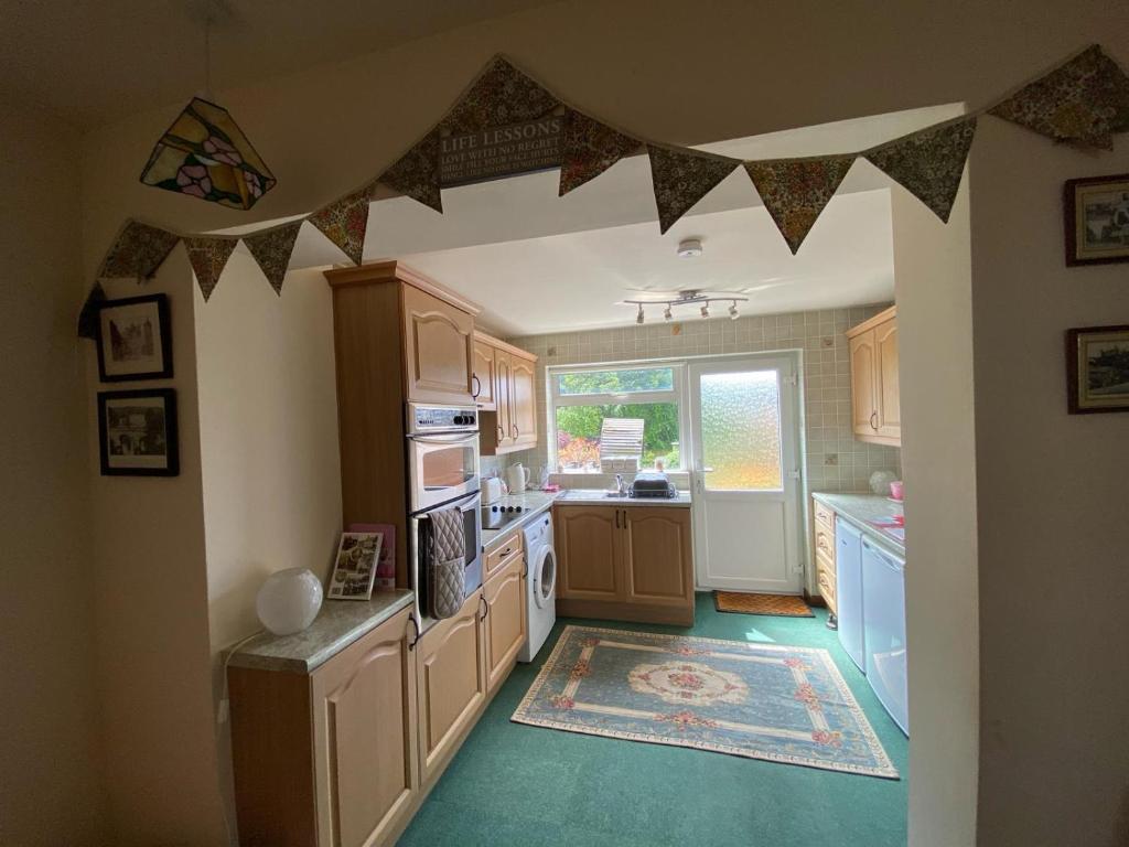 a kitchen with a flag hanging from the ceiling at IronPig Cottage in Cheadle