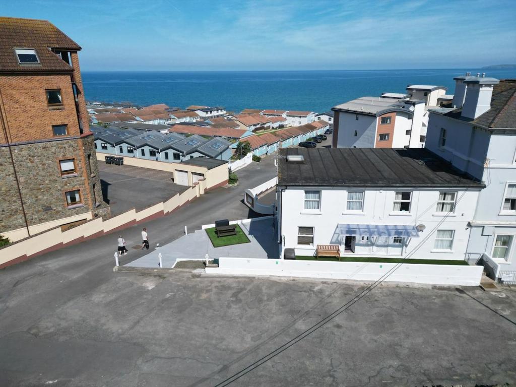 an aerial view of a town with the ocean at Flat White in Westward Ho