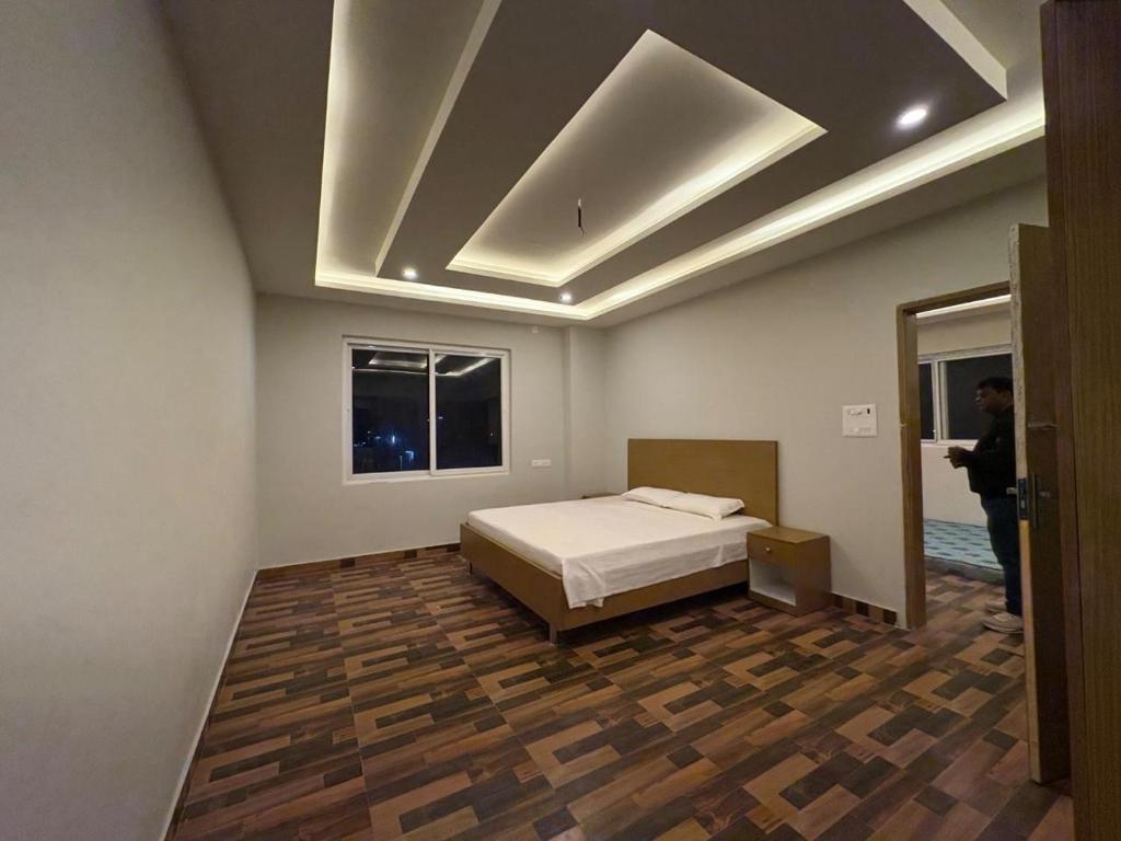 a bedroom with a bed and a mirror in it at Lagoon Resort in Suitha