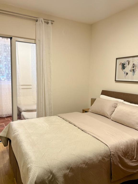 a bedroom with a bed and a window at Kanber Inn in Budva