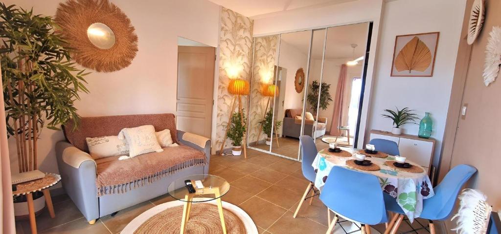 a living room with a couch and a table at Ti Ker Créole in Saint-Benoît