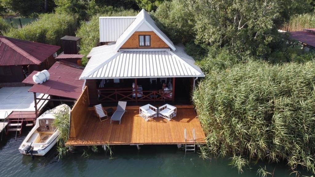 an aerial view of a house on the water at Dori Cottage in Ada