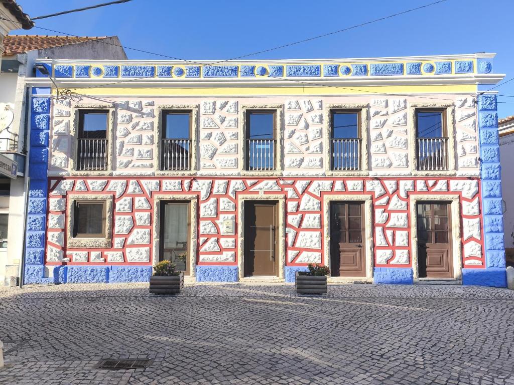 a building with blue and white tiles on it at Casa da Praça - Obidos Country Residence in Amoreira