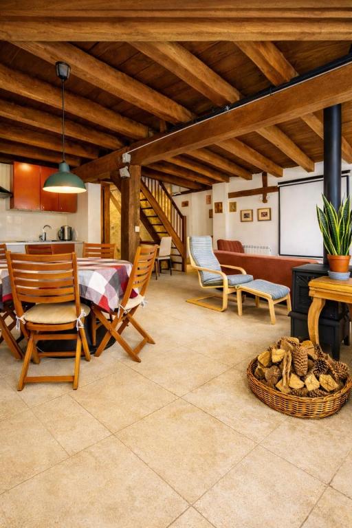 a kitchen and dining room with a table and chairs at Casa Adrados Mar de Pinos con Patio y Barbacoa in Adrados