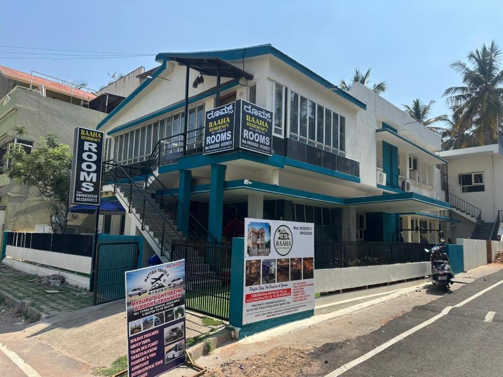 a building with signs in front of it at Raaha Residency in Mysore