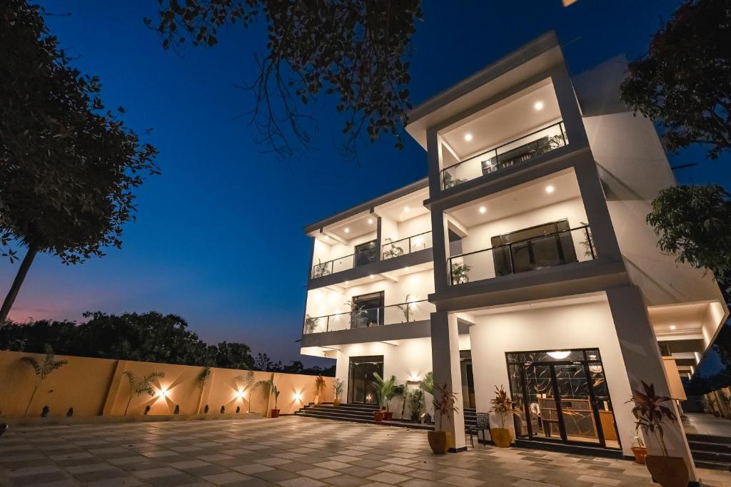 a large white house at night at White Forest - PV Hotels in Pondicherry
