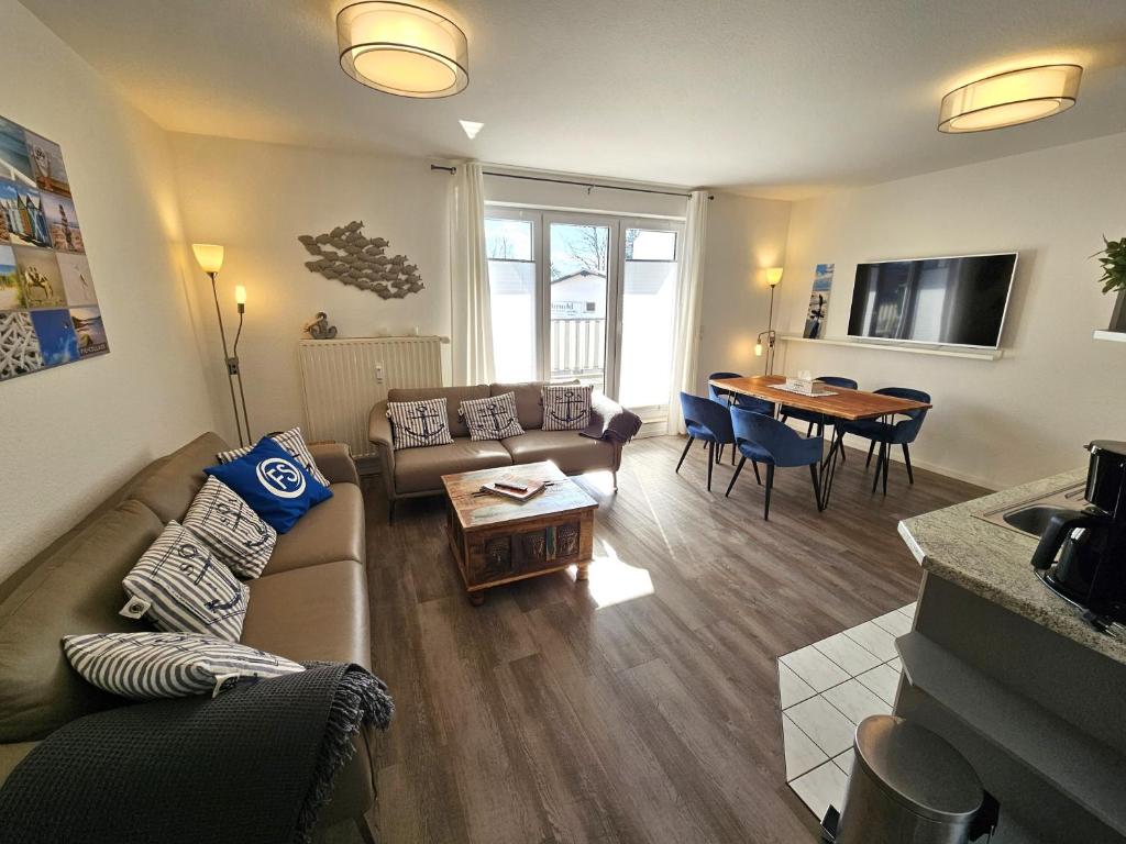 a living room with a couch and a table at FeWo "Seebär" Whg2 in Dahme