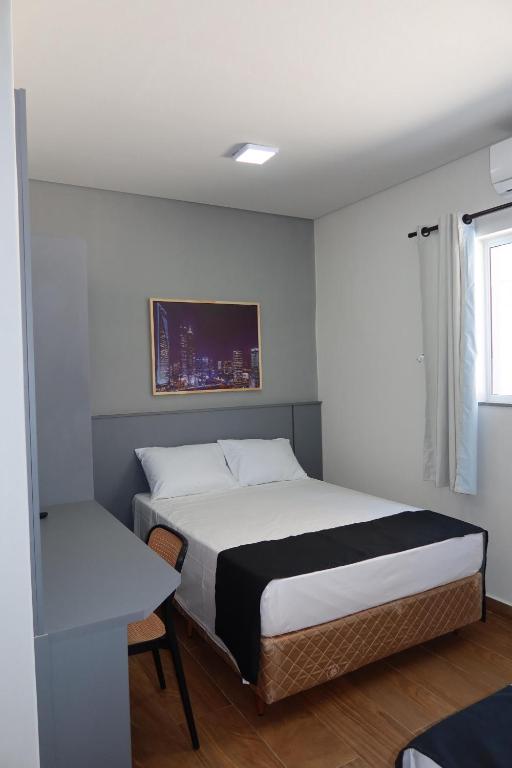 a small bedroom with a bed and a window at B Hotel 888 hotéis - Próximo a Rodoviária e Praça Sete in Belo Horizonte