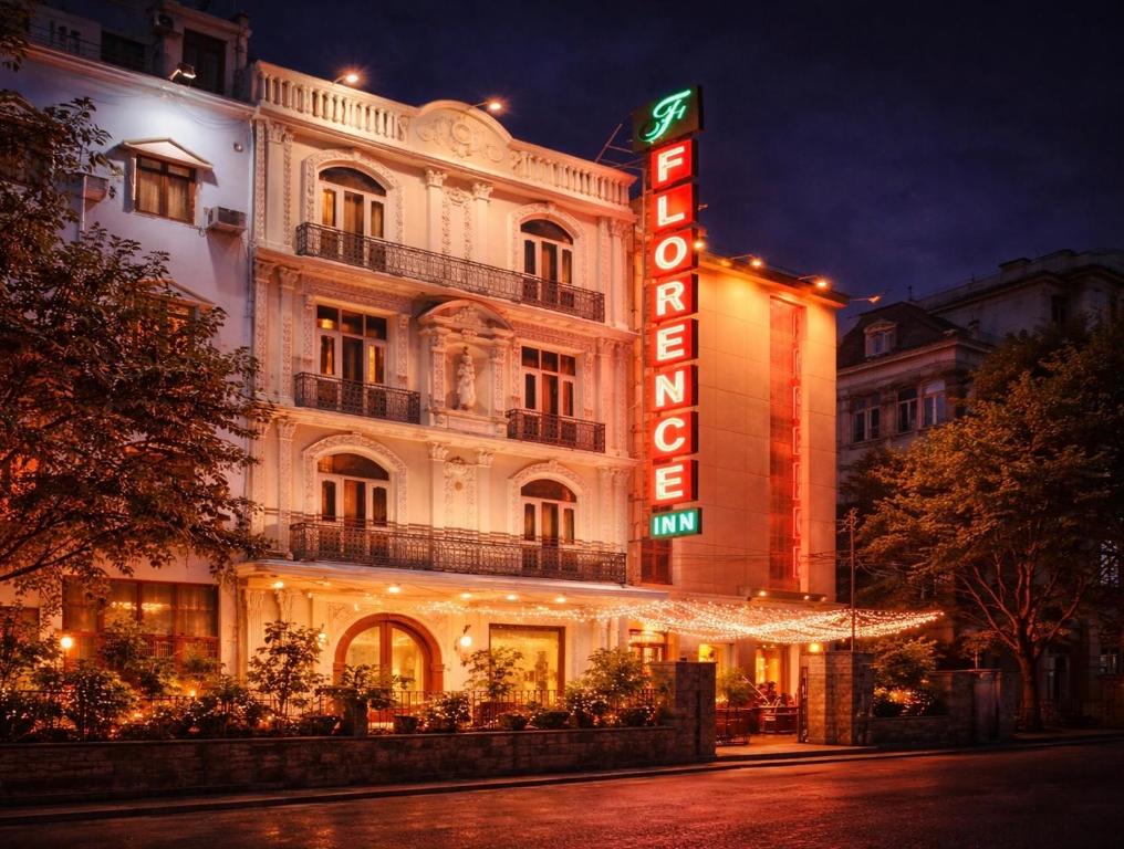 a hotel with a neon sign in front of it at Hotel Florence Inn, Karol Bagh, New Delhi, 2 Min from Metro in New Delhi