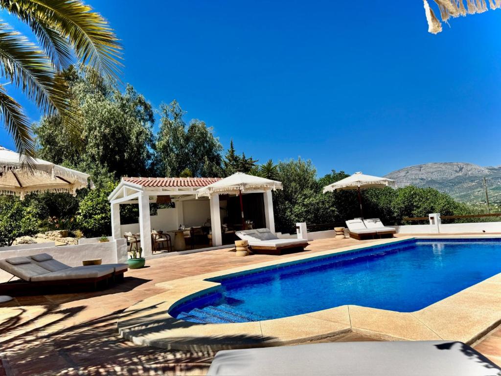 a villa with a swimming pool and a patio at Vida Lenta Boutique Finca in Alora