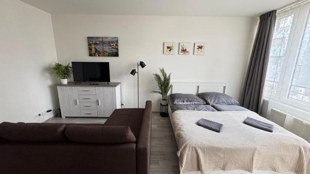 a living room with two beds and a couch at THE RIVERSIDE APARTMENT with Balcony in Prague