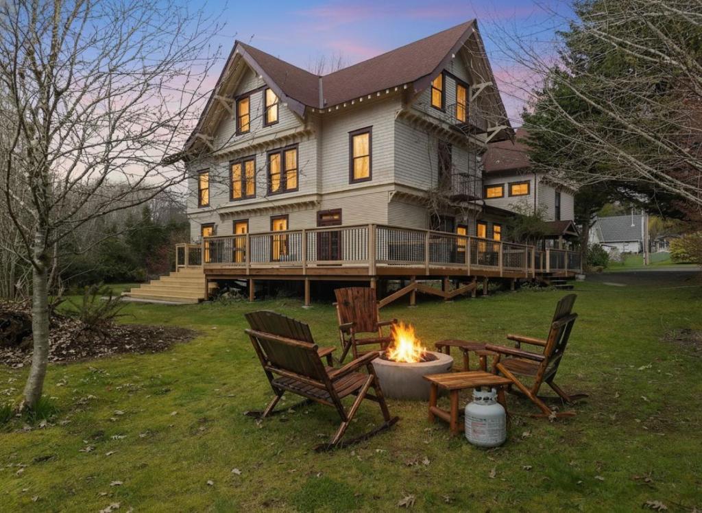 a large house with a fire pit in the yard at McCleary Hotel in McCleary