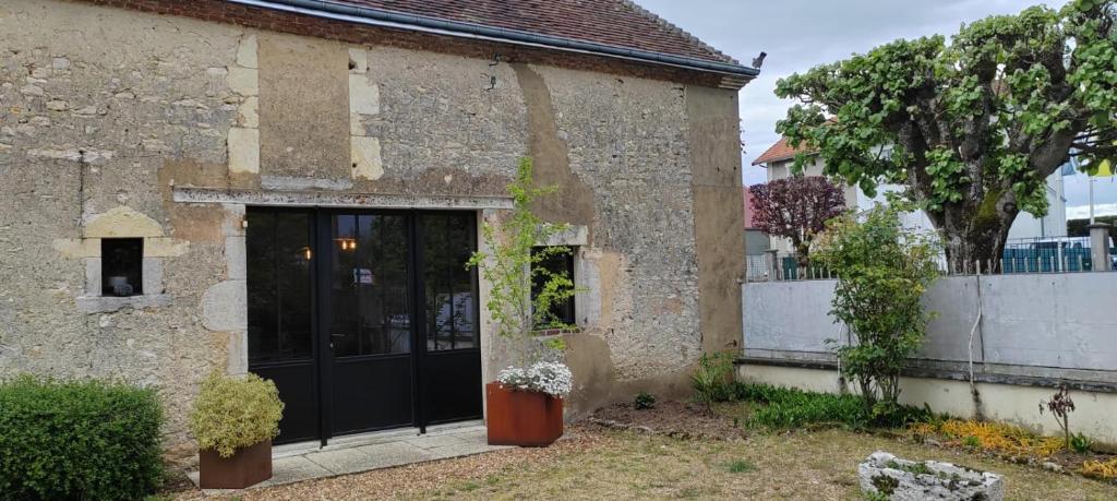 a building with a black door and a fence at location 24h du Mans in La Ferté-Bernard