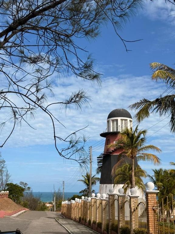 a lighthouse with a fence in front of it at Villa Nautilus Be Happy in Fortaleza